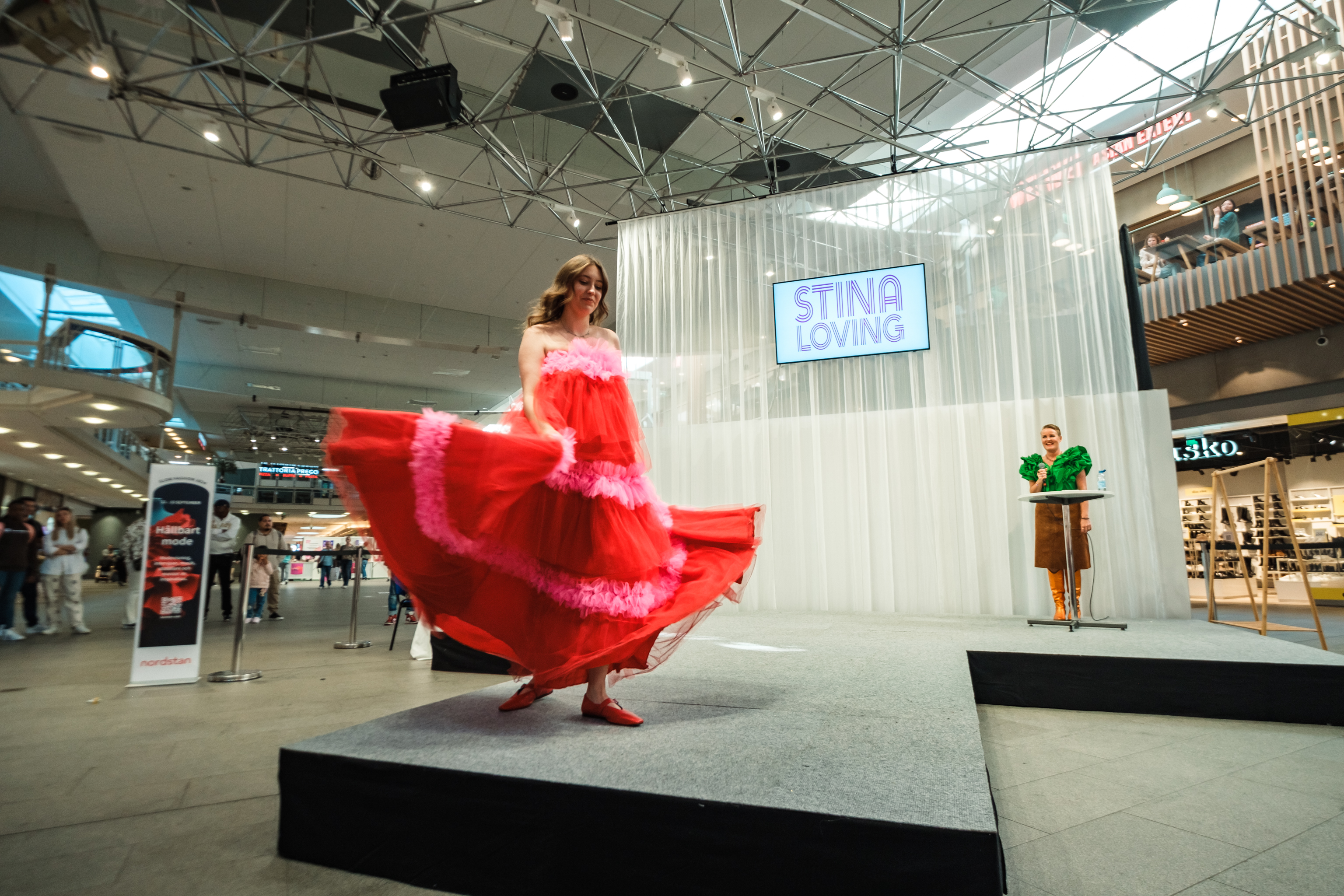 Woman in red dress on catwalk