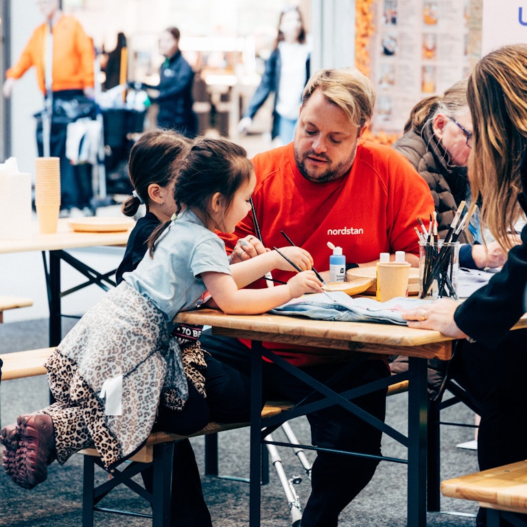 Young girl painting in event area