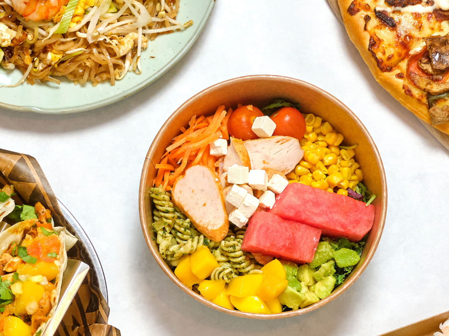 Plates showing pizza, sallad, sushi, tacos ans thai food