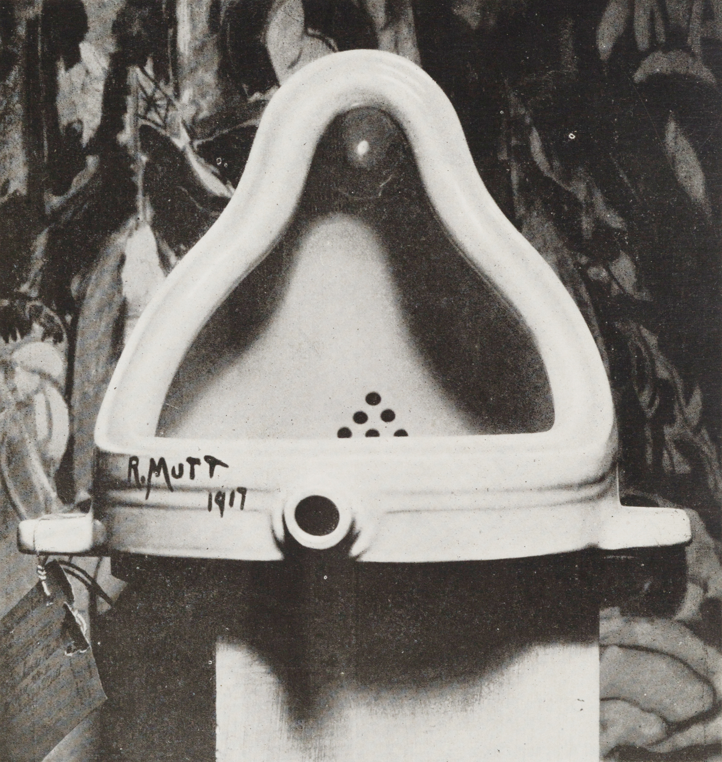 A porcelain urinal positioned upright, photographed in black and white.
