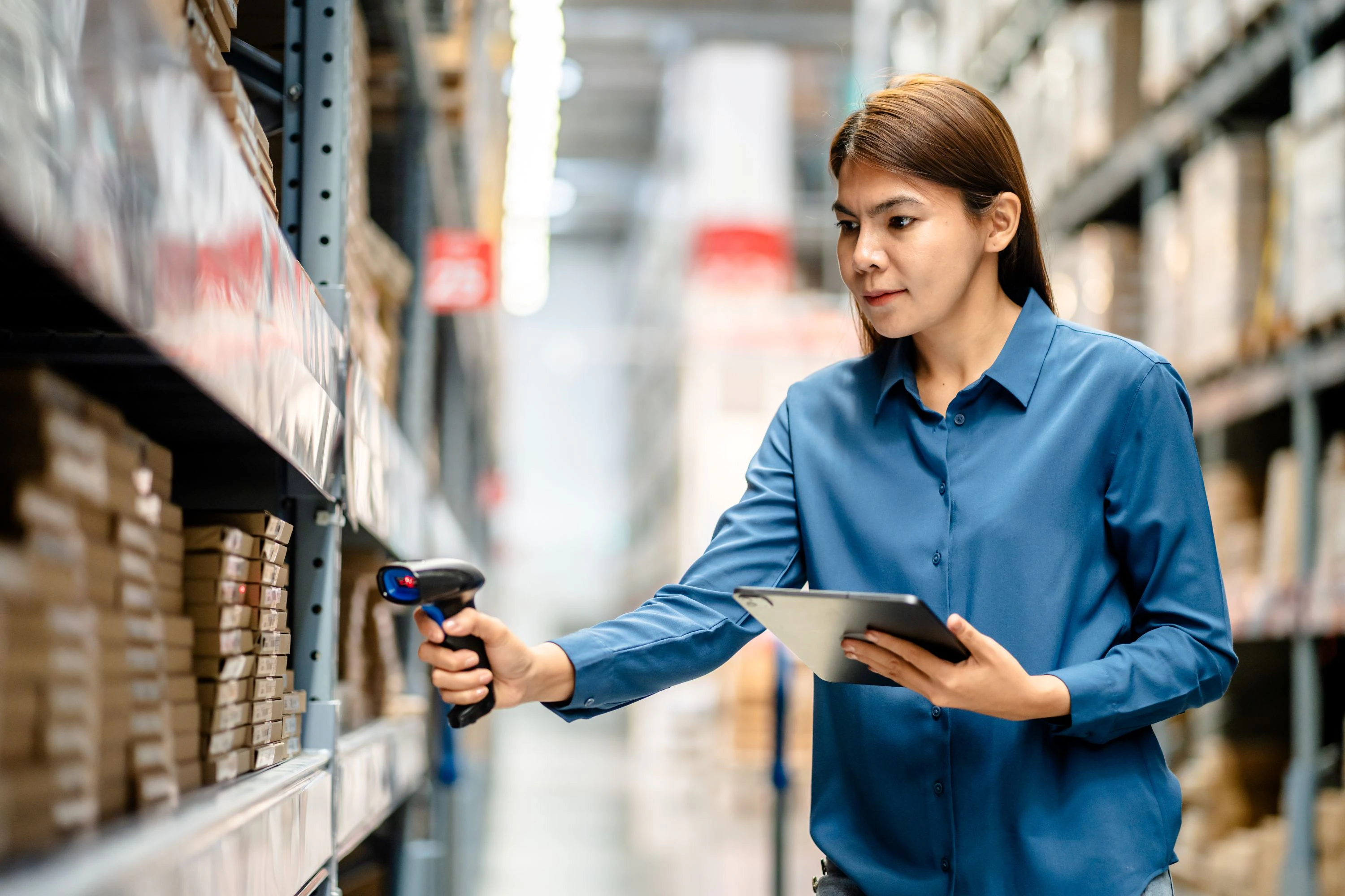 woman scanning inventory with barcode reader
