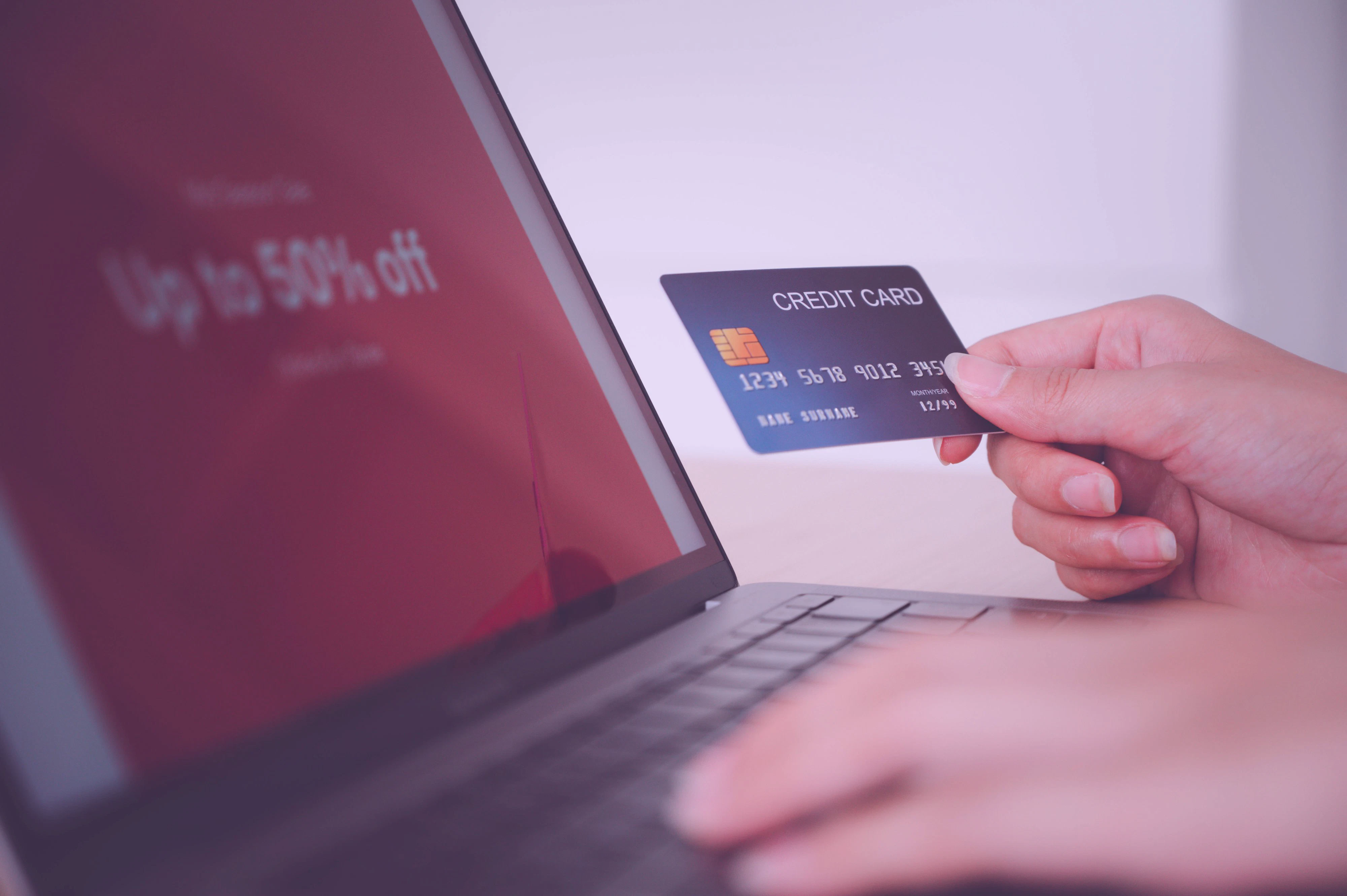 Woman holding a credit card and shopping online