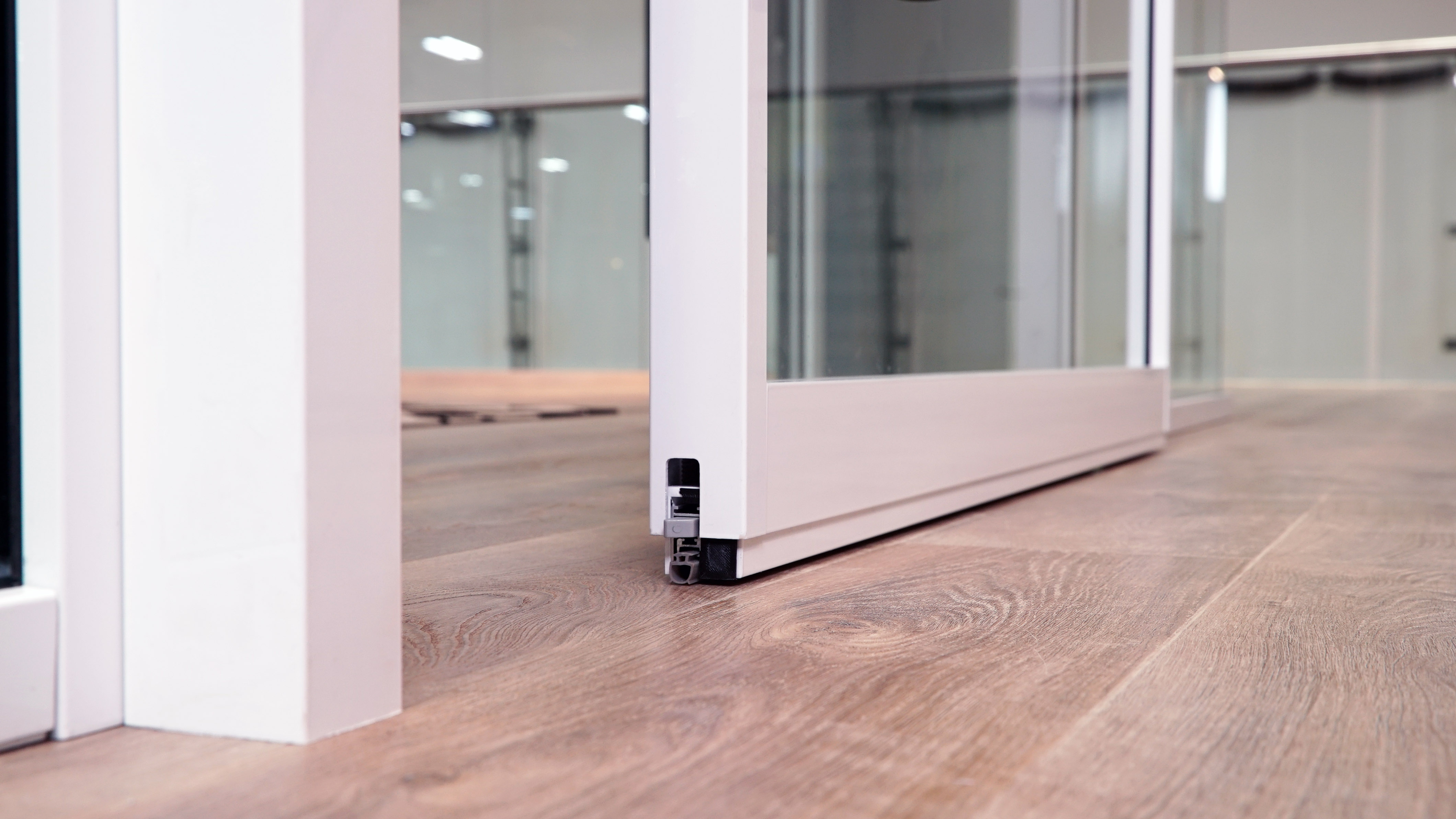 Falkbuilt Calgary retail glass door drop seal acoustics