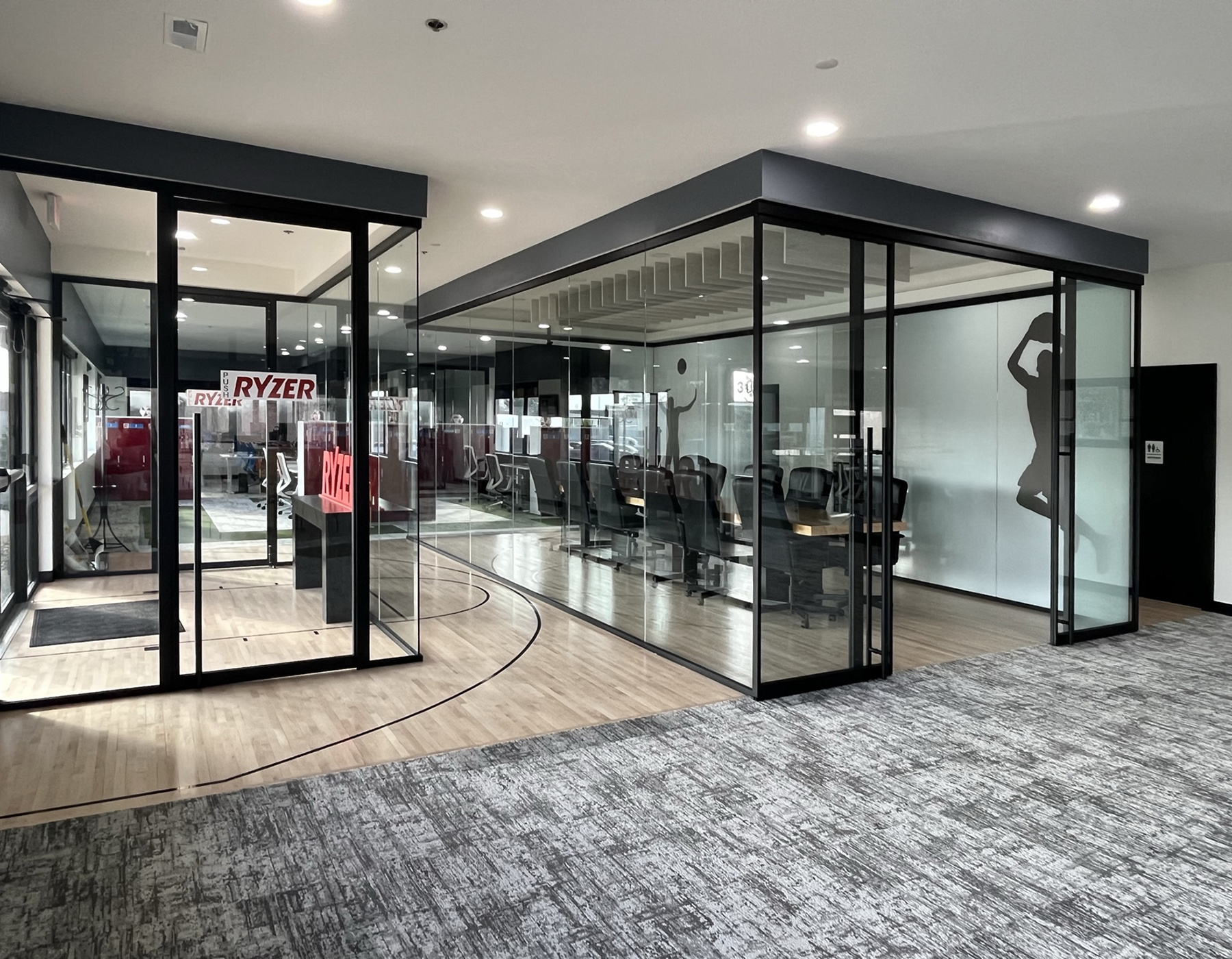 Interior view showcasing Falkbuilt's glass wall construction in a corporate setting.