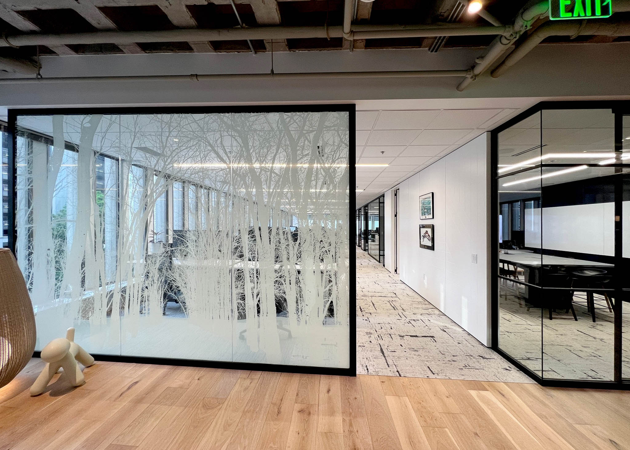 Interior view showcasing Falkbuilt's glass walls with custom frosting in a corporate setting.