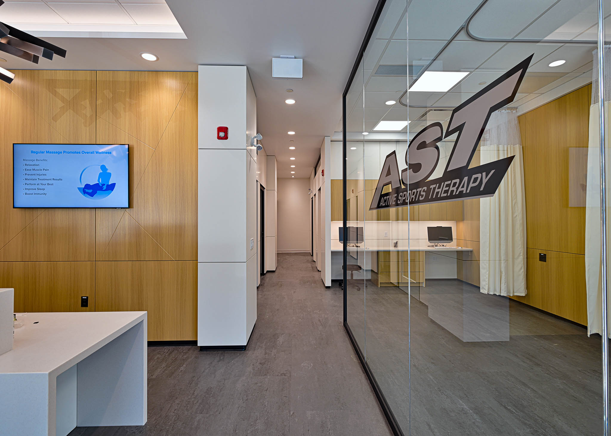 Interior view showcasing Falkbuilt's glass wall construction in a healthcare setting with custom graphics
