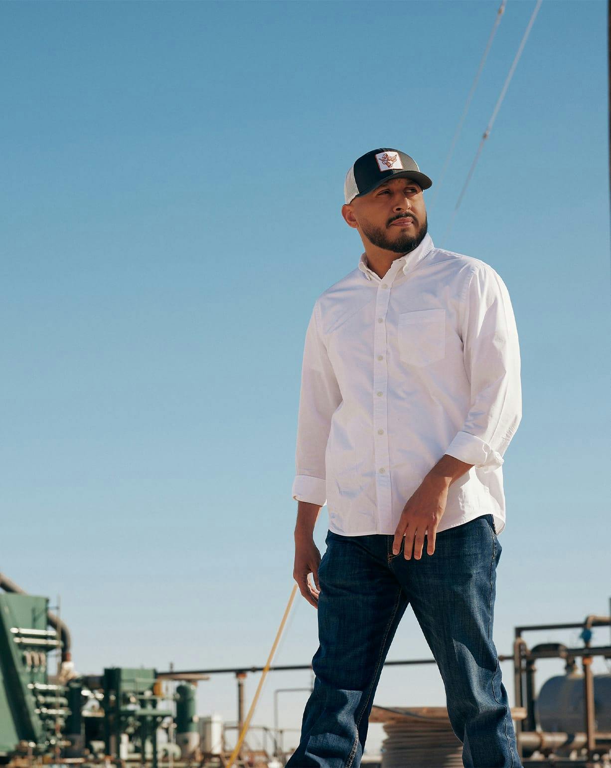 man in white shirt and hat on construction site