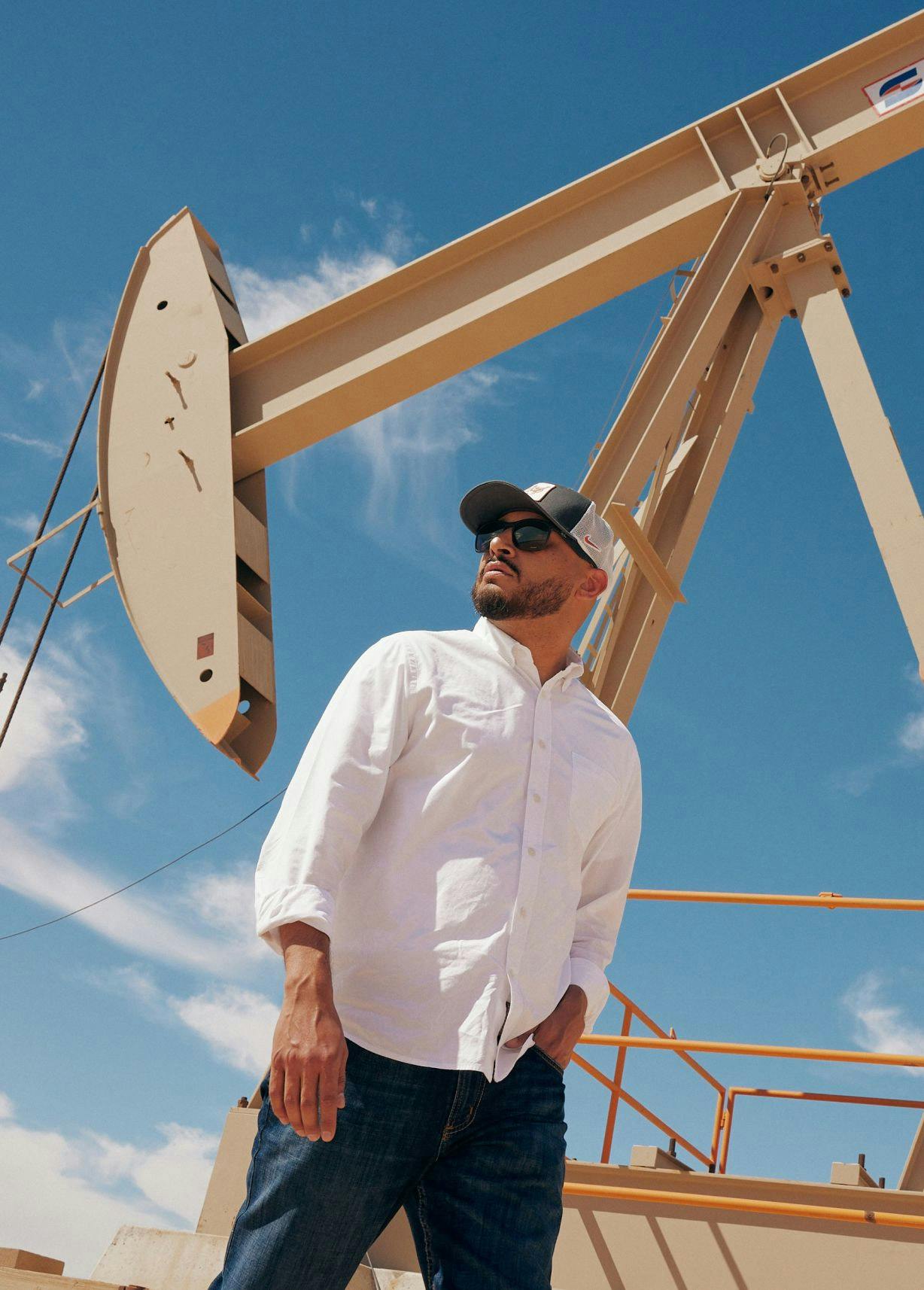Israel Medina visiting an oil site pumpjack.