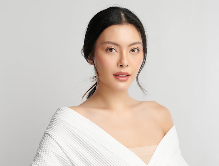 woman in white dress with low ponytail