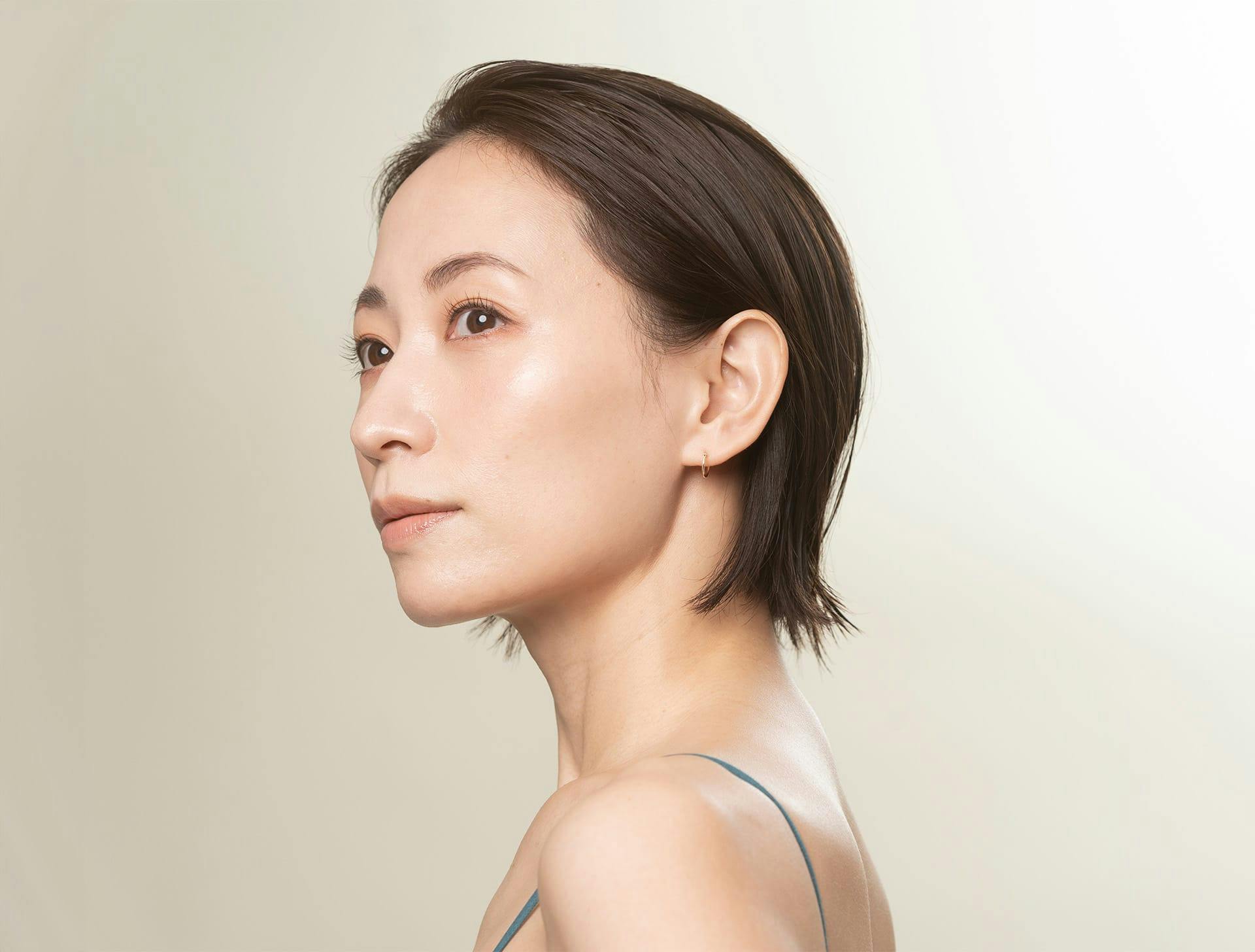 woman with short hair looking to the left