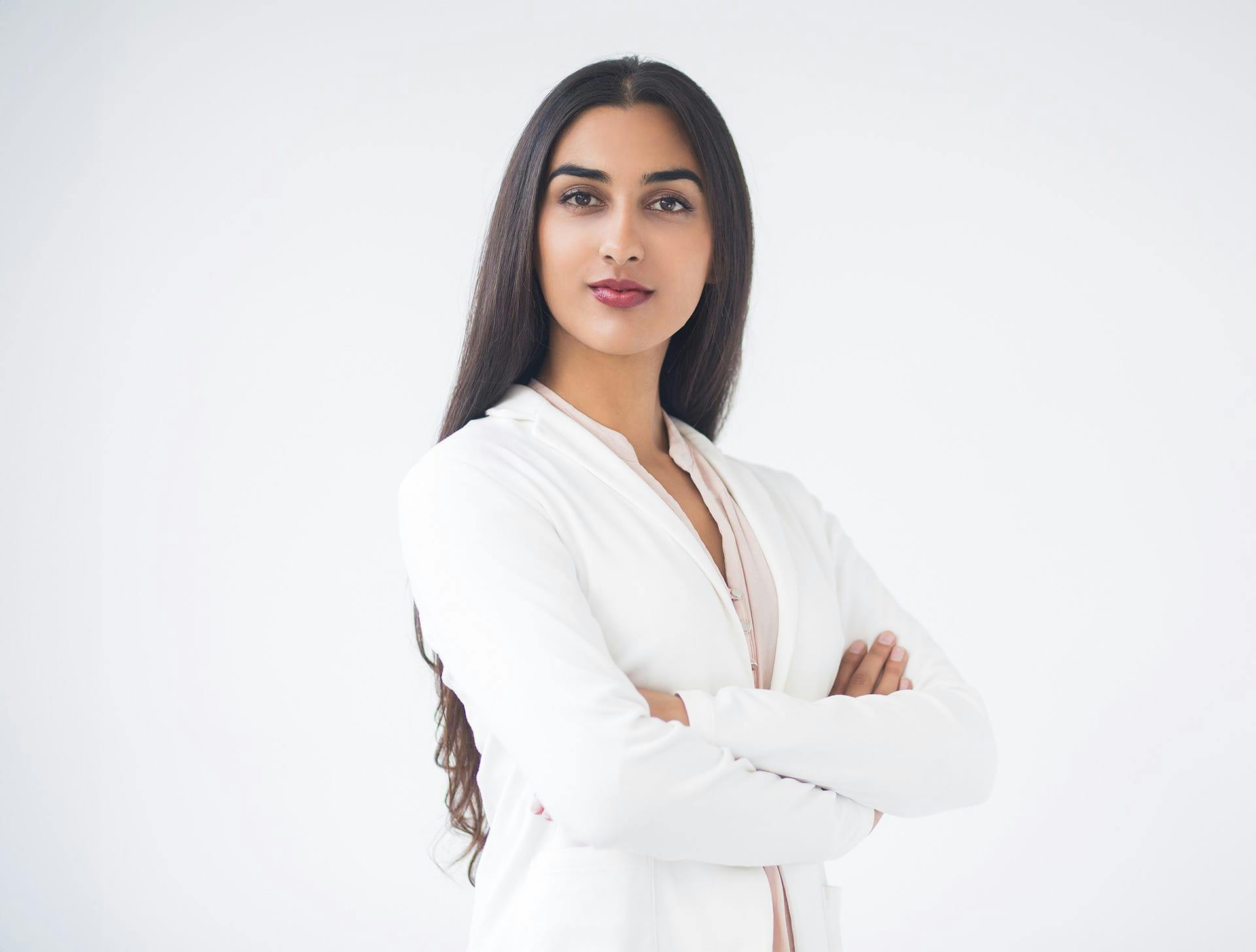 woman in white suit crossing her arms