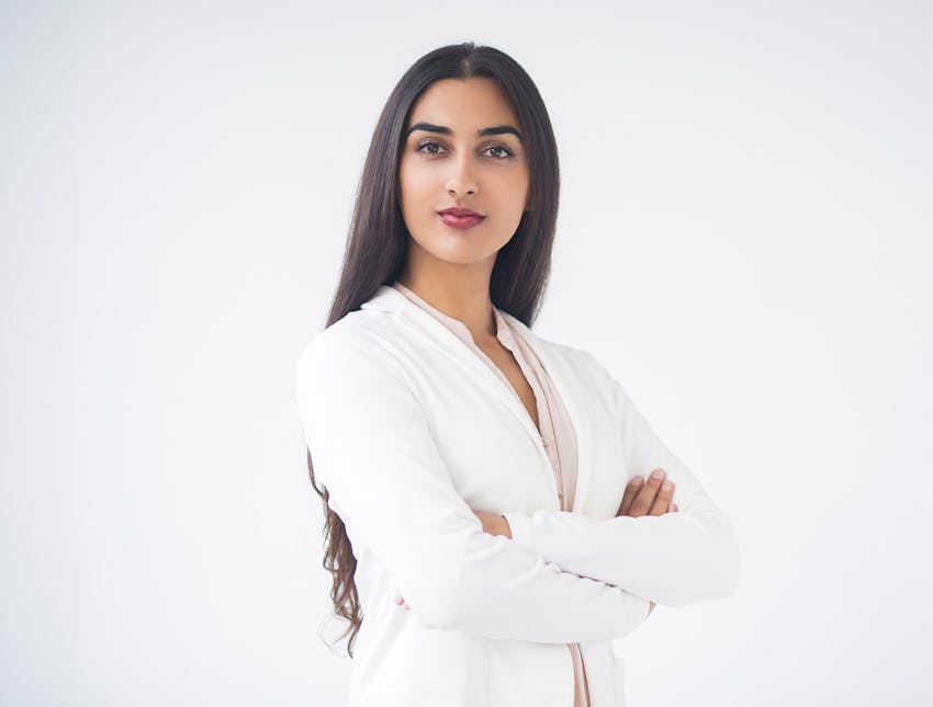woman in white suit crossing her arms