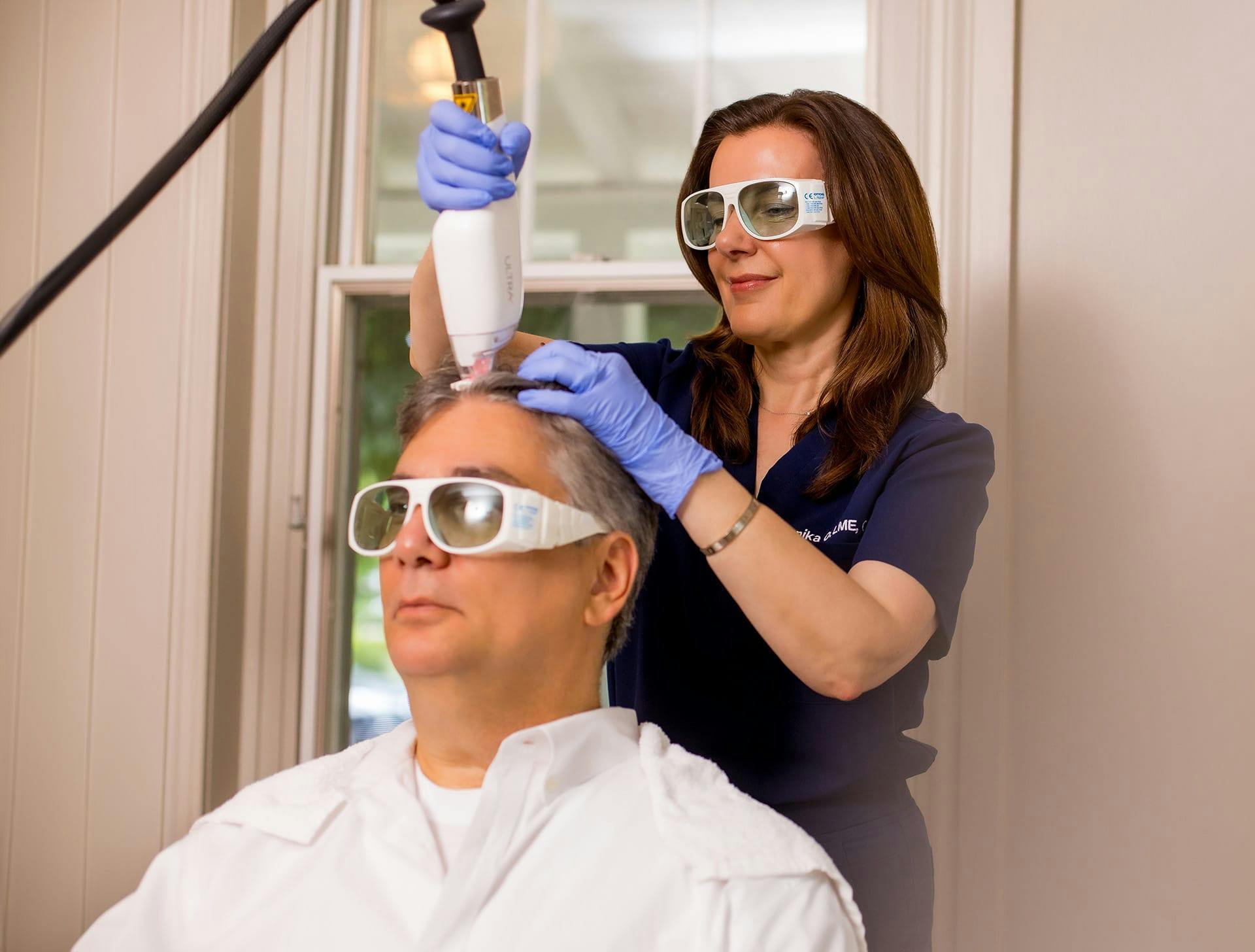 nurse doing hair restoration on male client