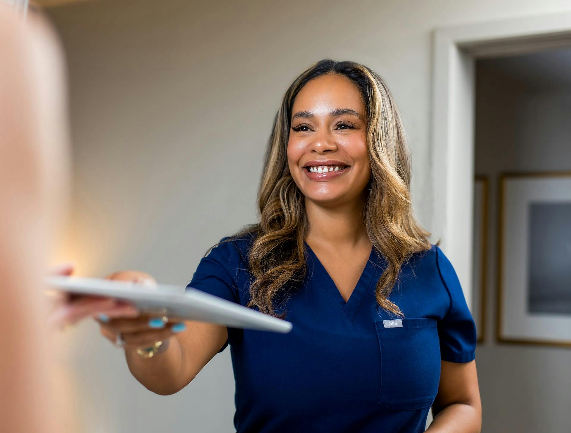 nurse giving client ipad
