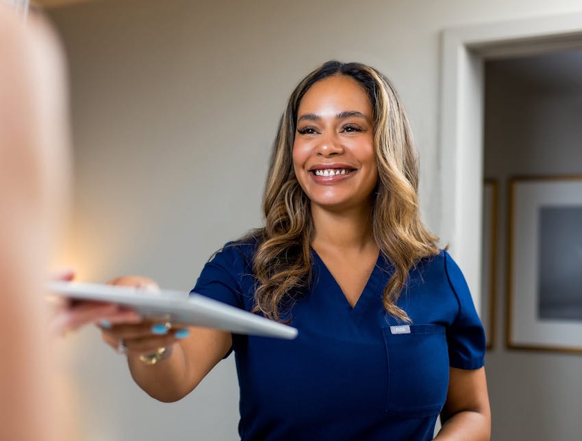 nurse giving client ipad