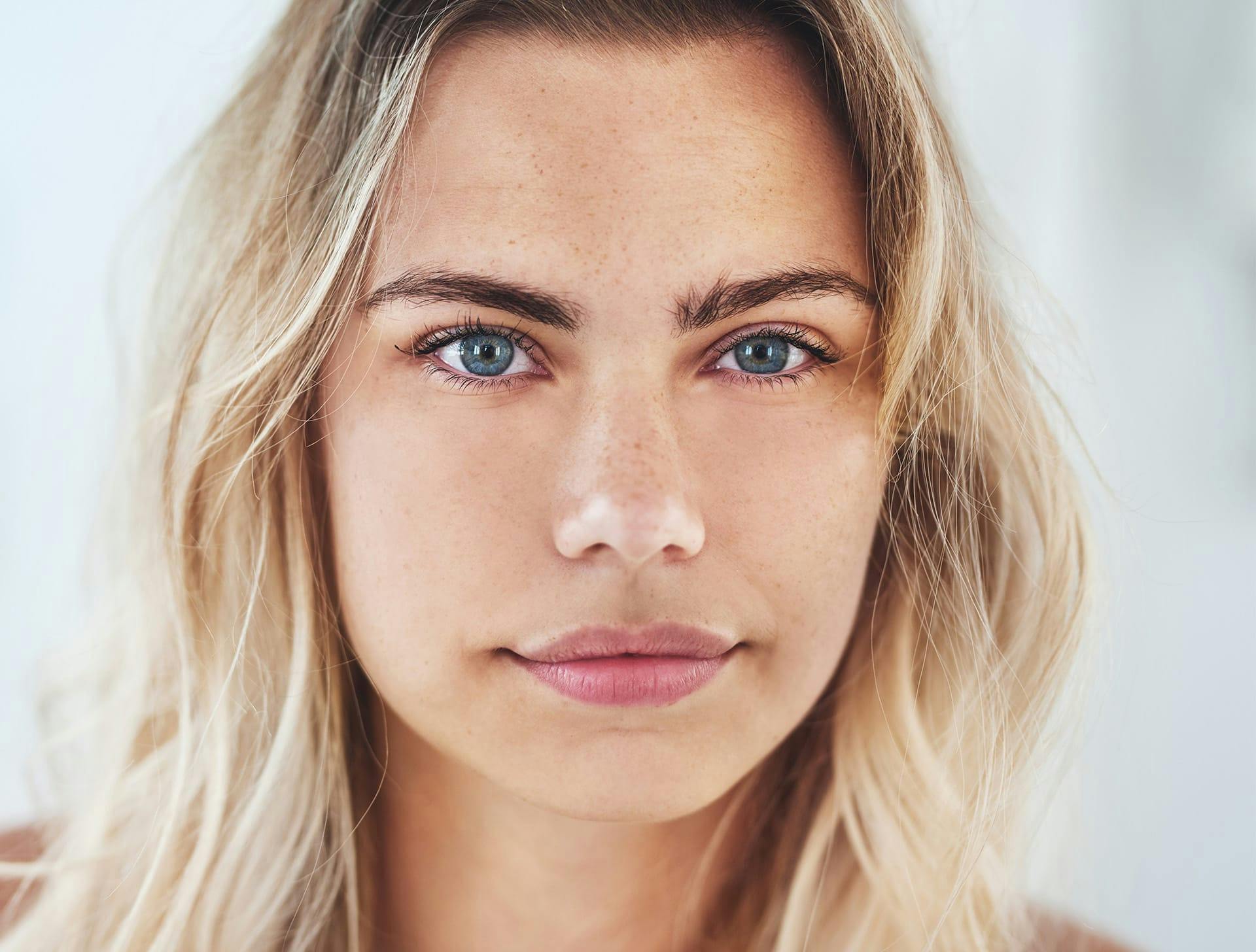 woman with beachy wavy hair with blue eyes looking foreward