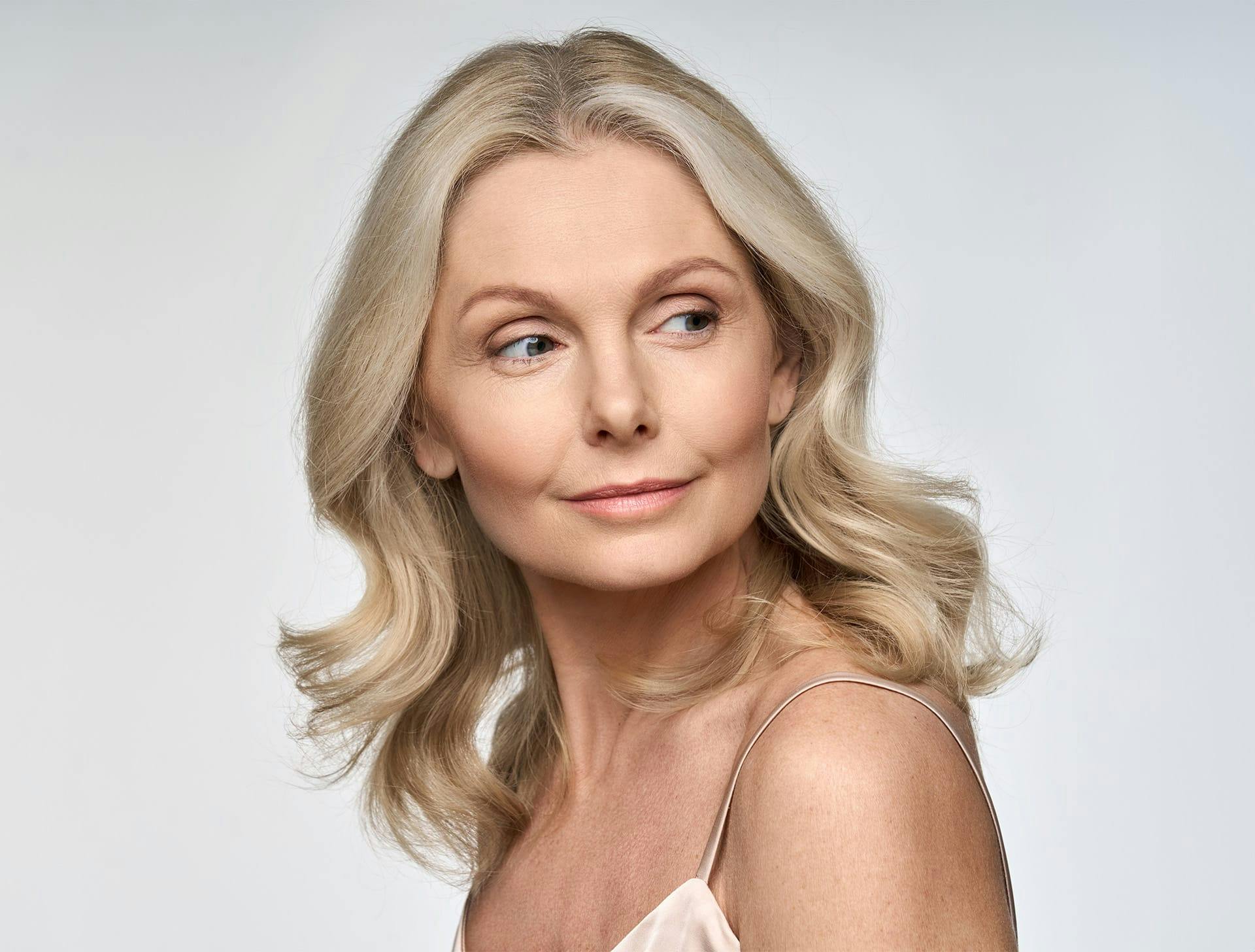 woman with blonde hair looking to the right