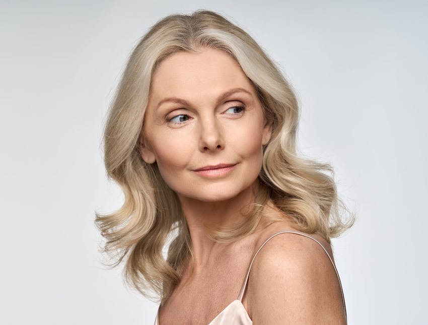 woman with blonde hair looking to the right