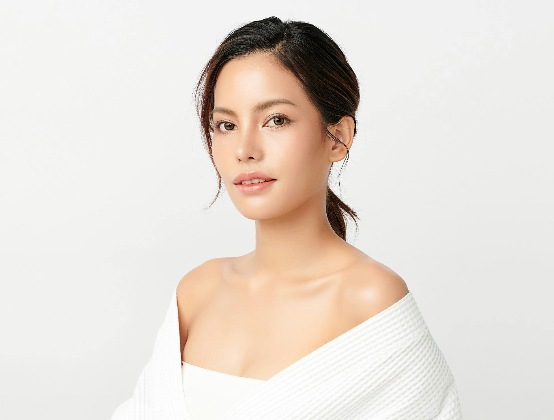 woman in white outfit with low ponytail