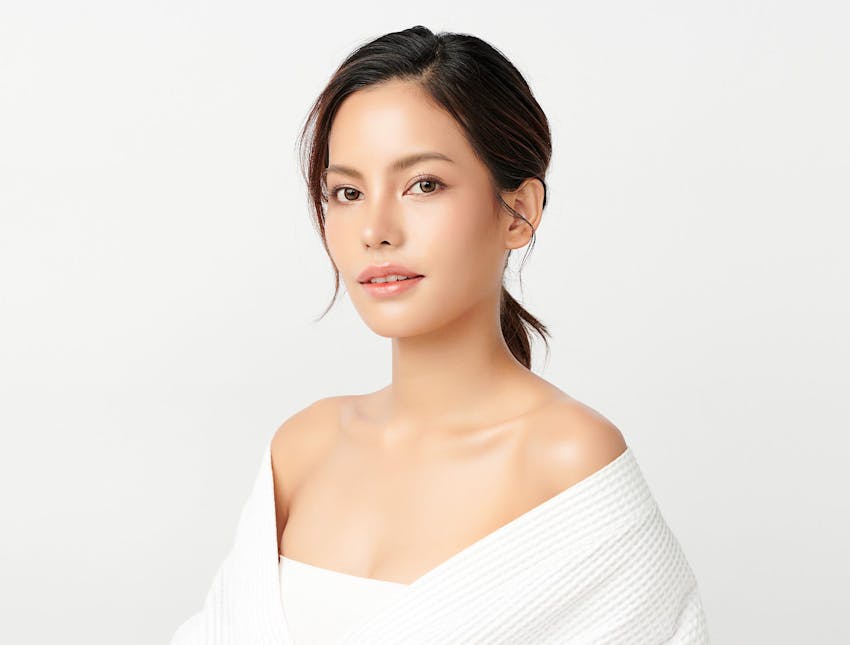 woman in white outfit with low ponytail