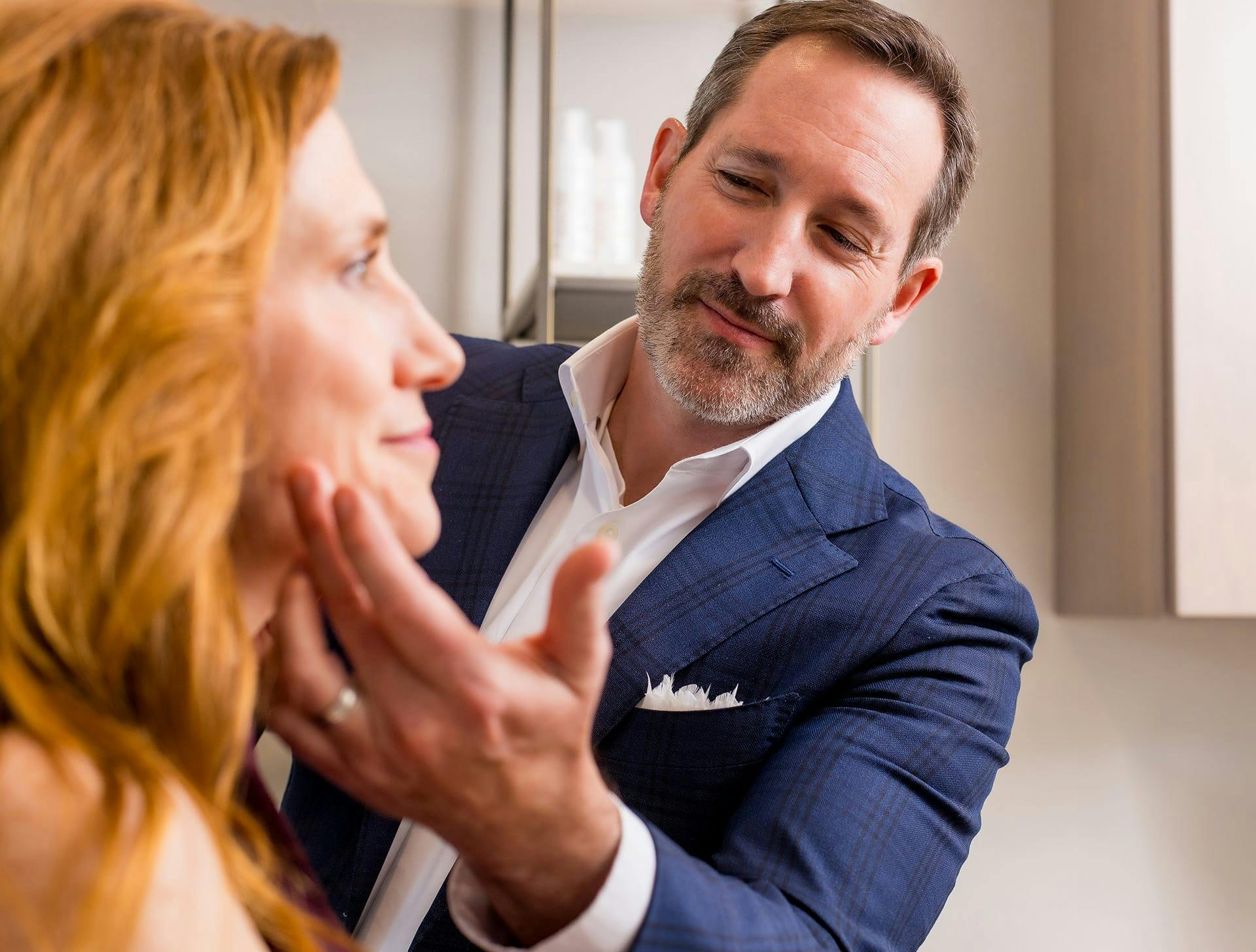 Dr. Morgenstern looking and touching clients face