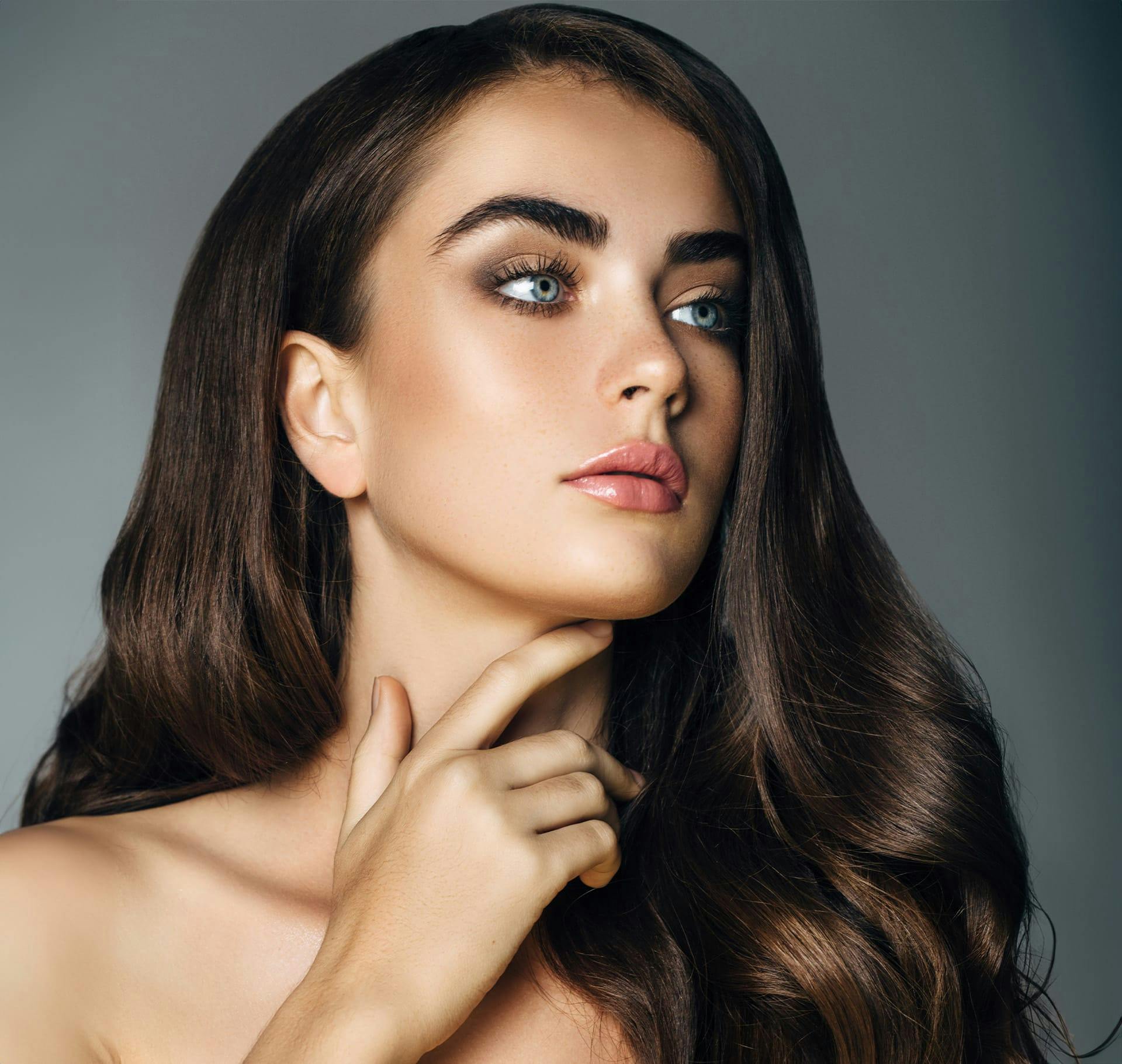 woman with thick eyebrows and long brunette hair