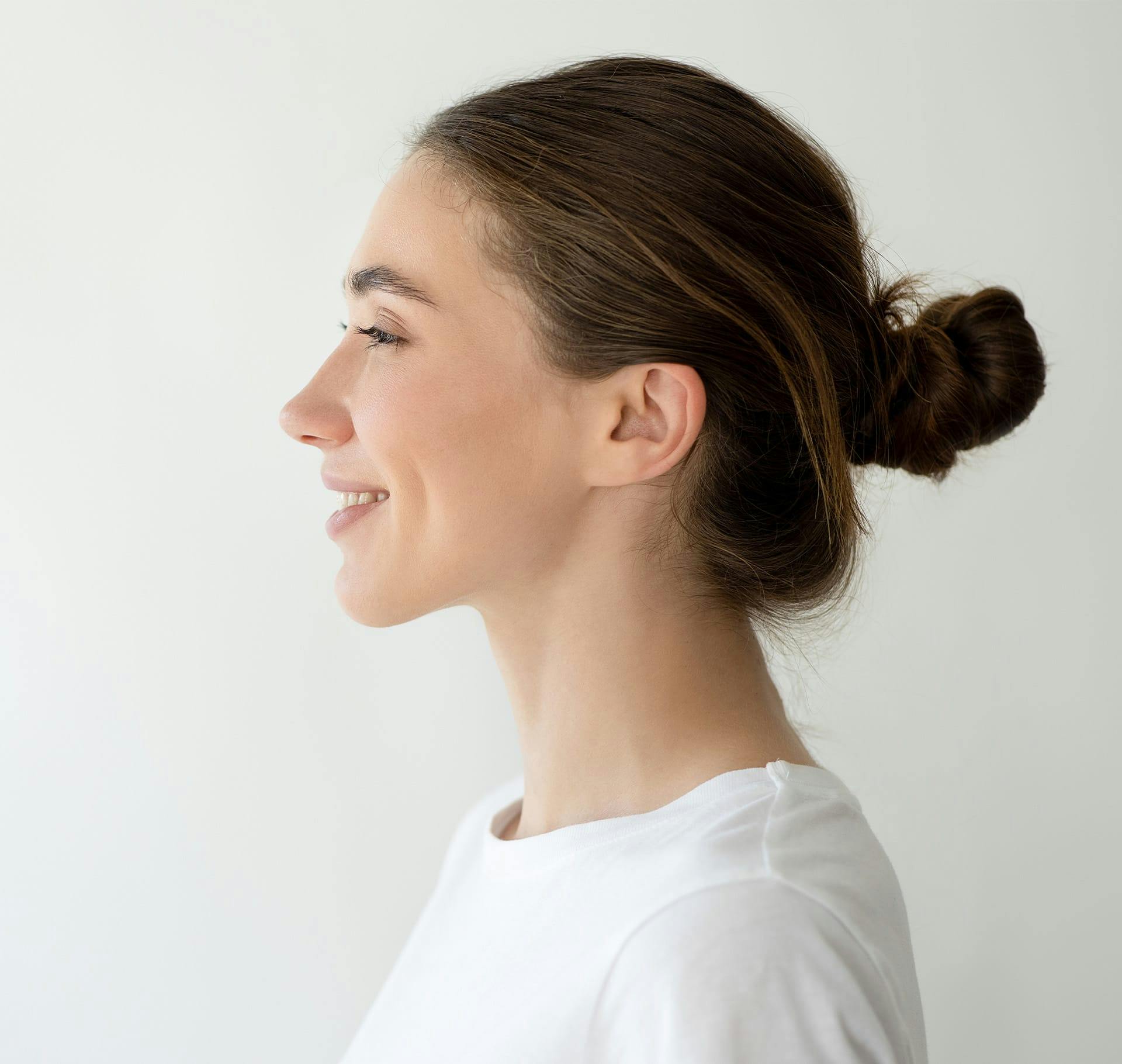 woman side profile with bun in hair