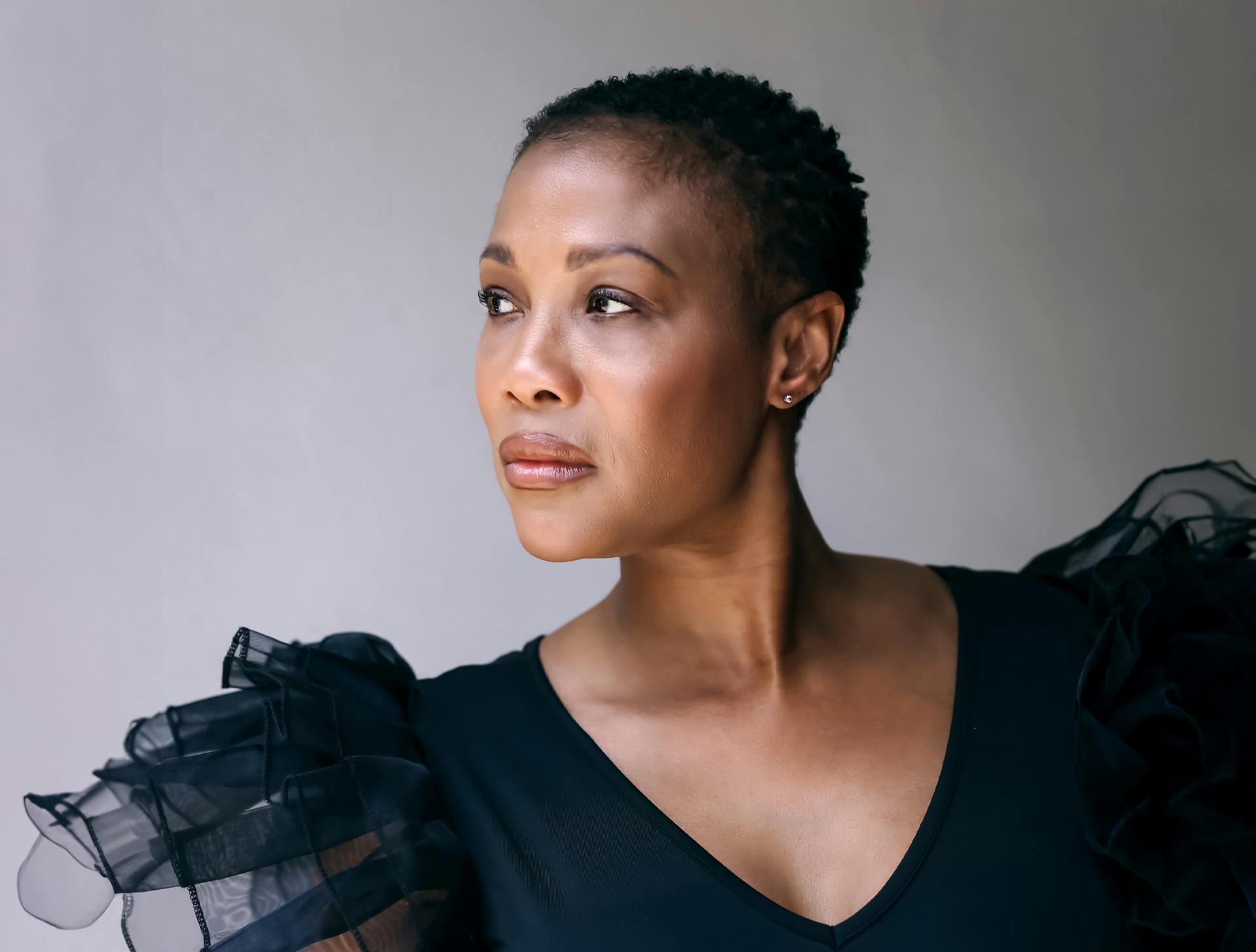 woman sitting with suit jacket over her shoulders