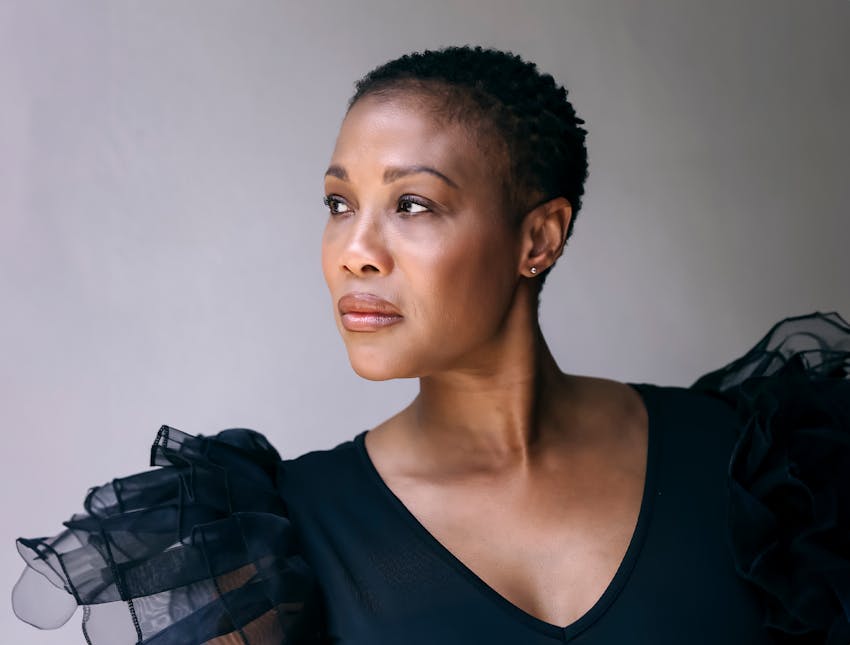 woman sitting with suit jacket over her shoulders