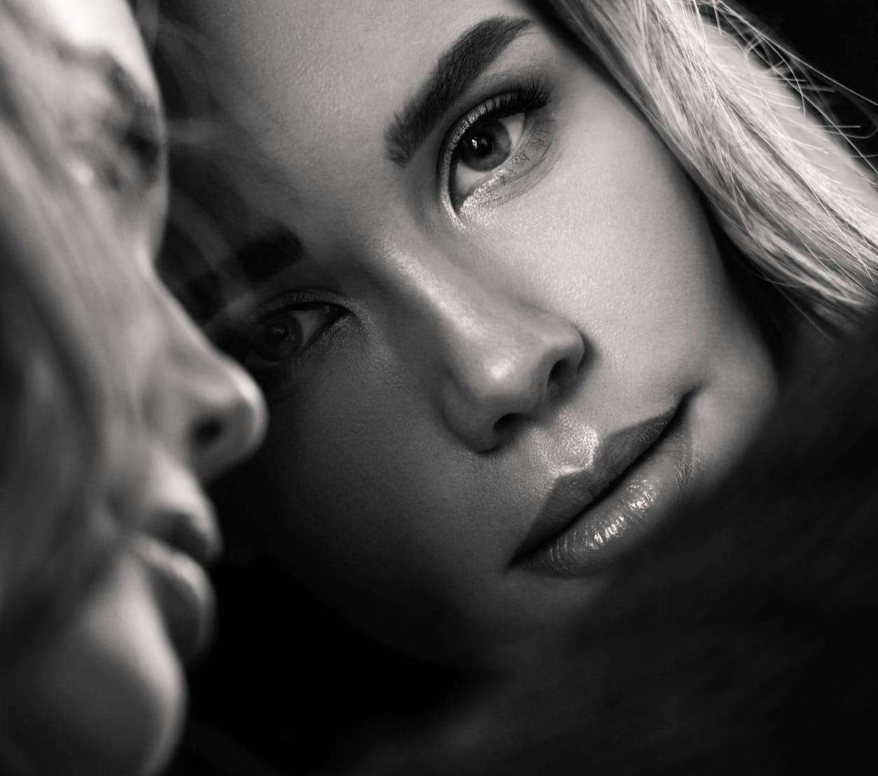 Woman looking at her face in the mirror