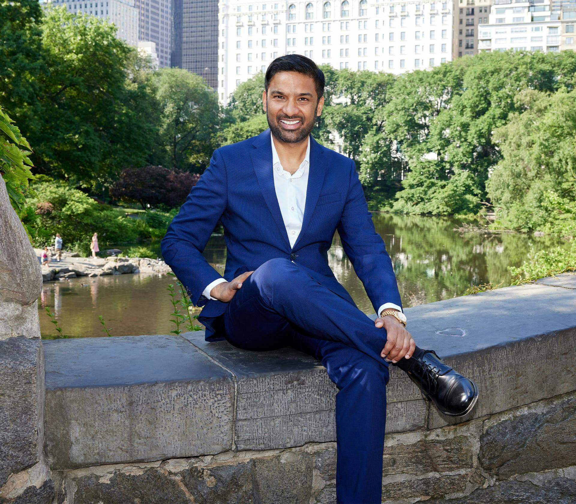 Dr. Singh sitting and smiling