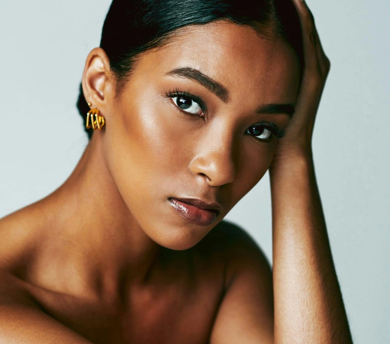 beautiful dark skinned woman wearing gold earrings