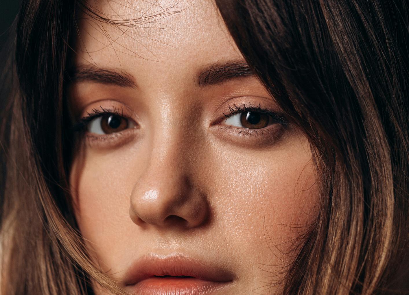 close up shot of woman's youthful face to show the ptoential results of eyelid surgery in NYC