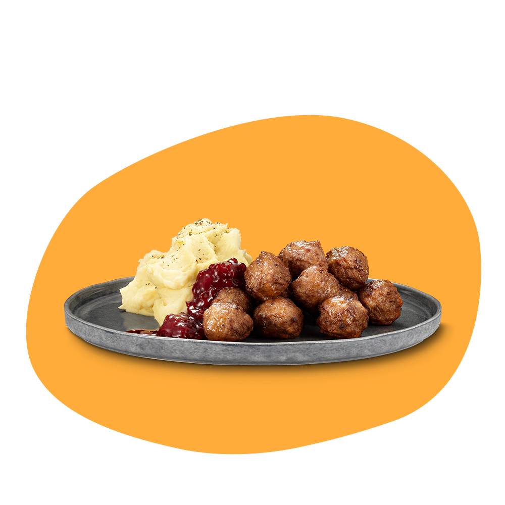 En tallrikmed potatismos, köttbullar och lingonsylt