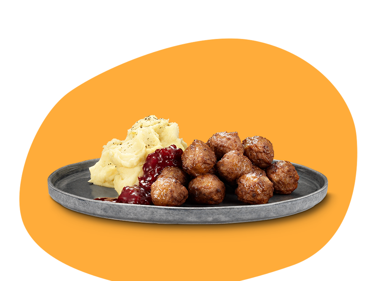 En tallrikmed potatismos, köttbullar och lingonsylt