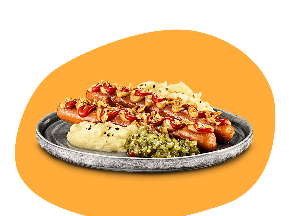 Tallrik med två vegokorvar med ketchup, senap, rostad lök plus potatismos och en klick bostongurka