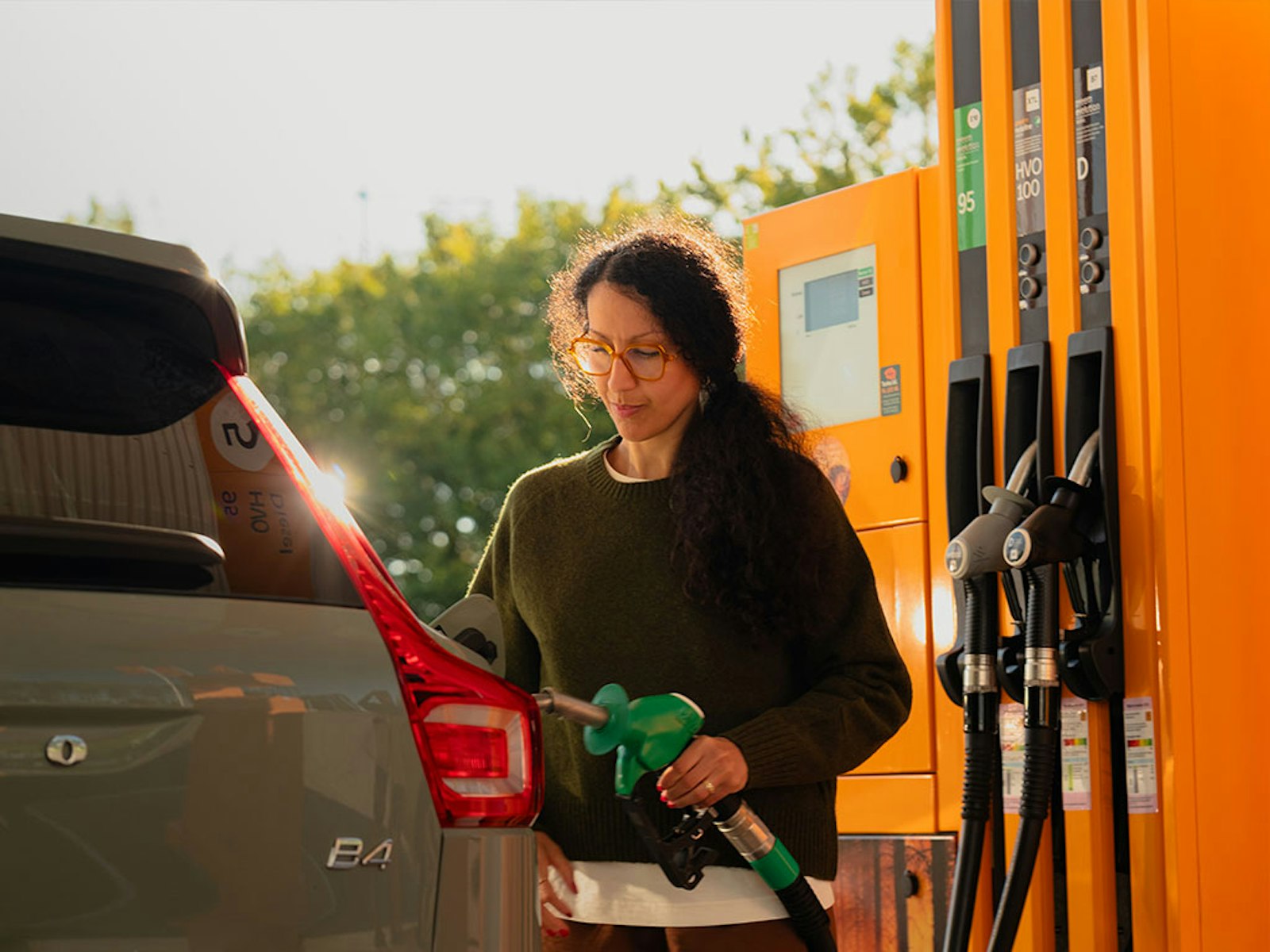 Kvinna tankar bil på en station
