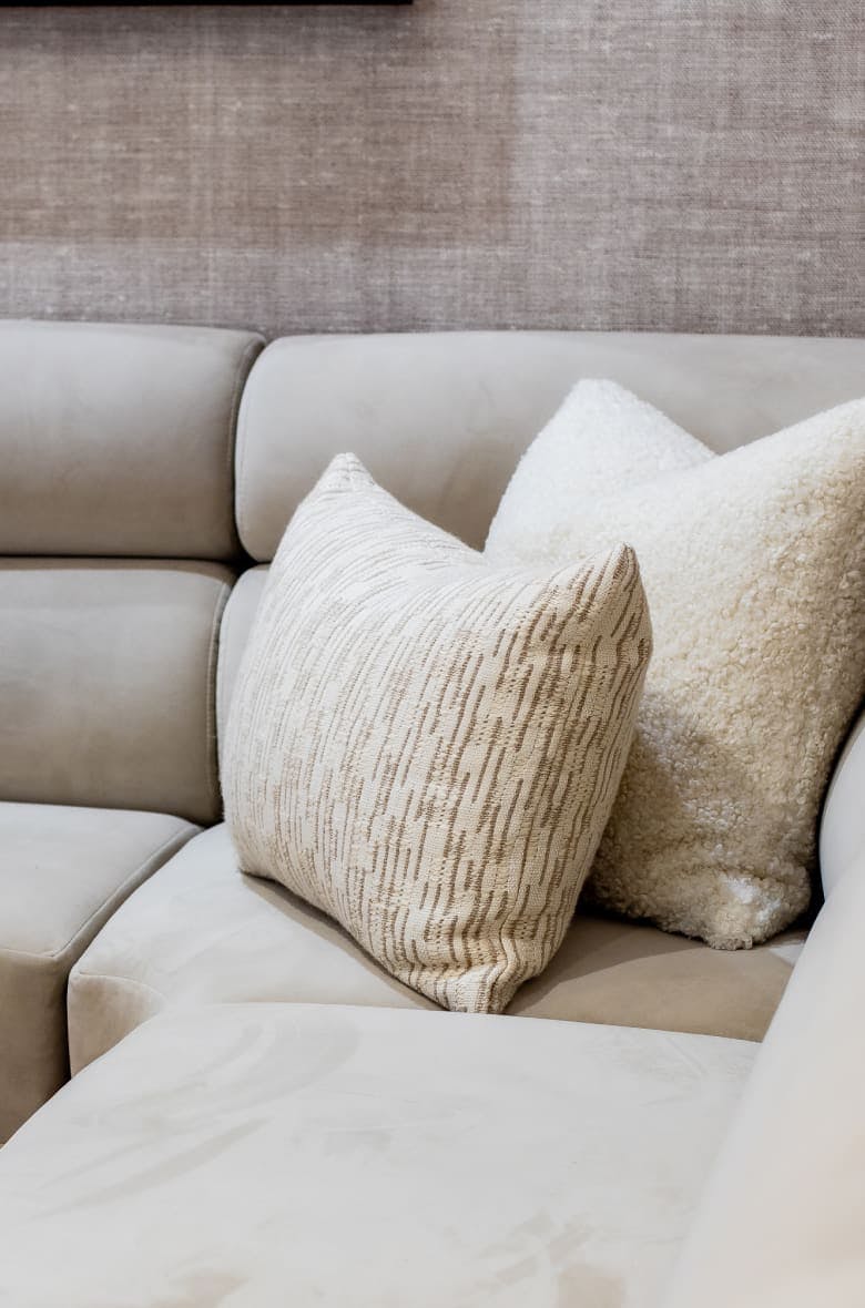 white couch with 2 white decorative pillows