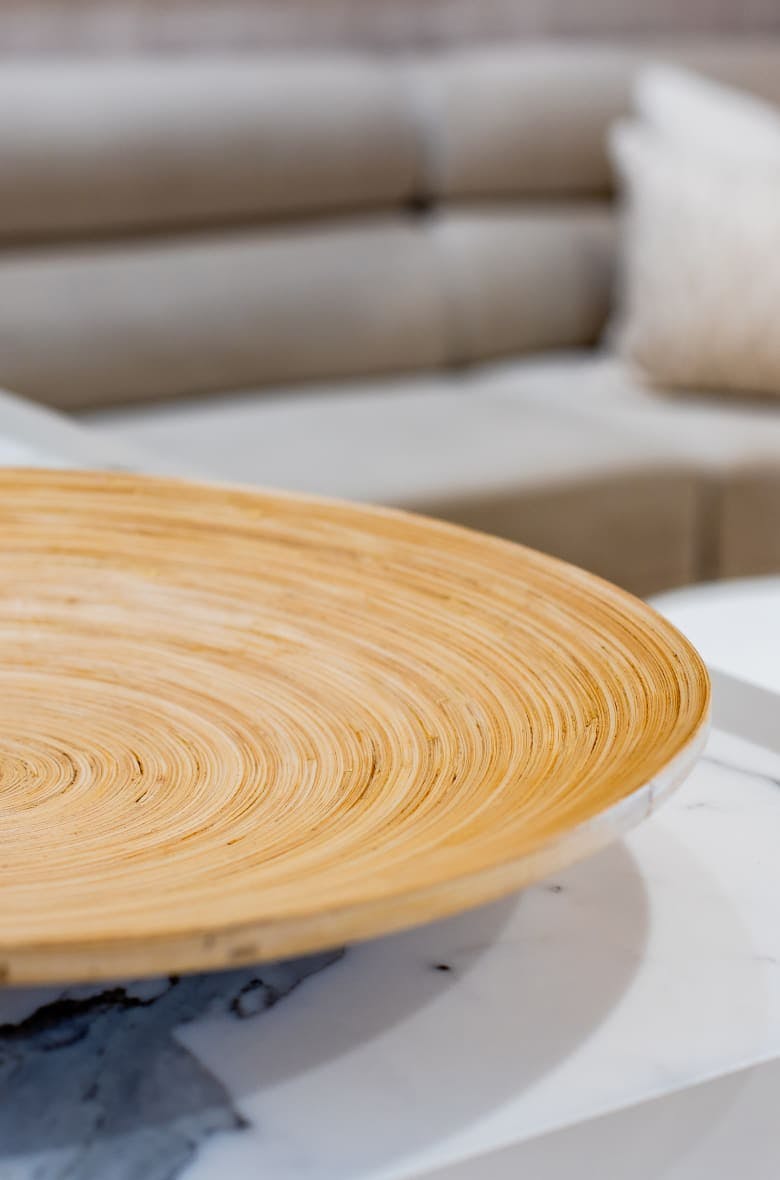 wooden bowl on table with couch in the background