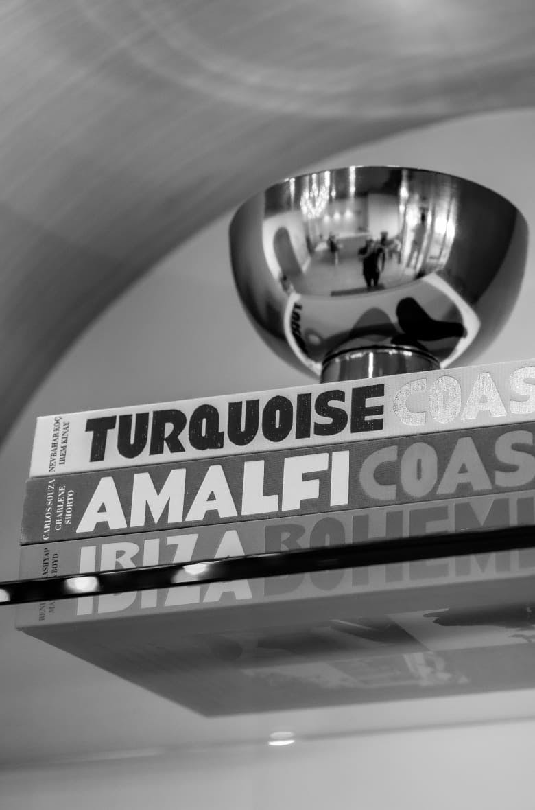greyscale of metal bowl on a stack of books