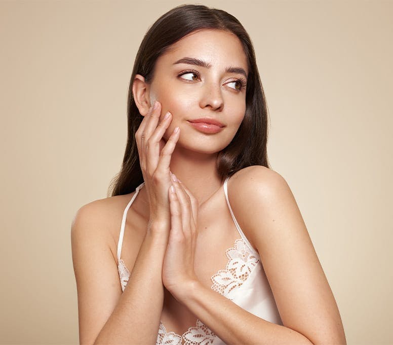 woman touching her face and looking to the right