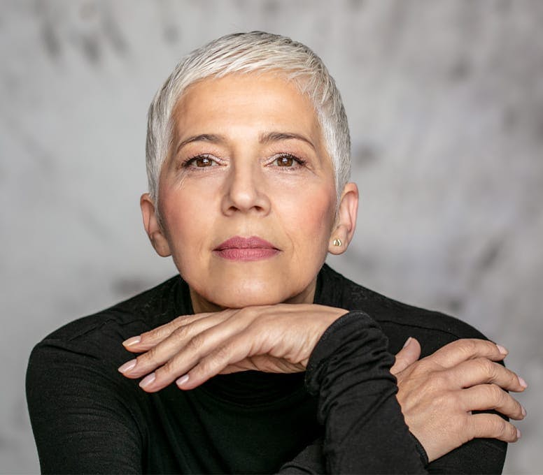 woman with short grey hair in a black long sleeve