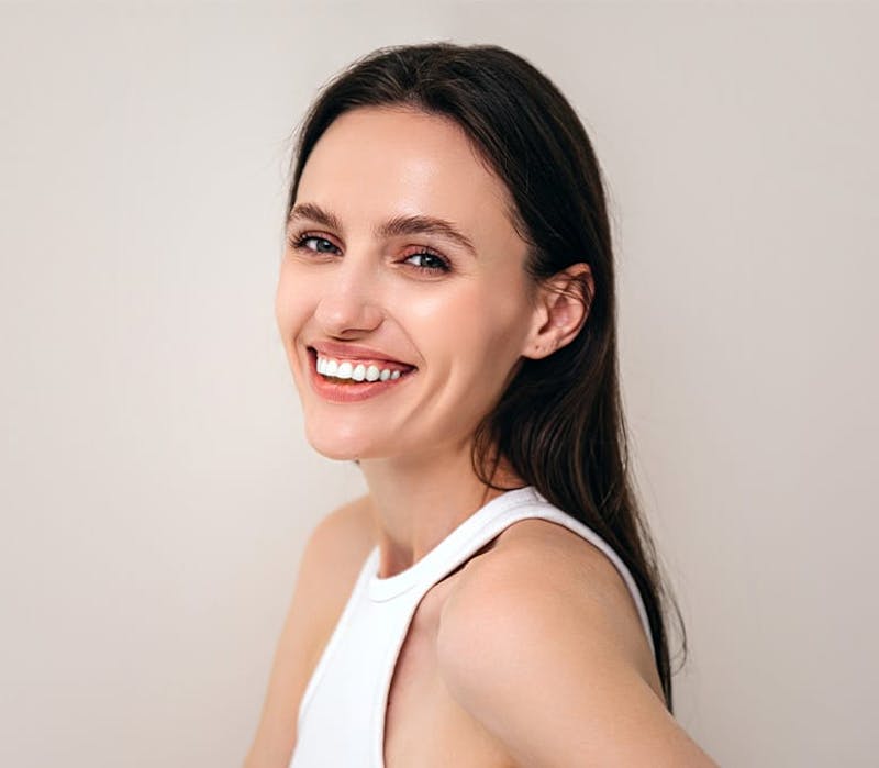 woman smiling while she body faces the left