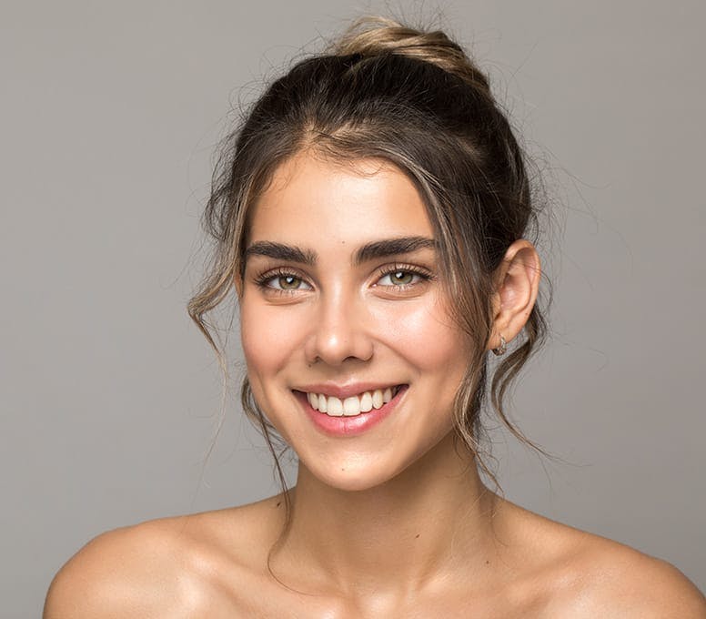 woman smiling with high bun in her hair