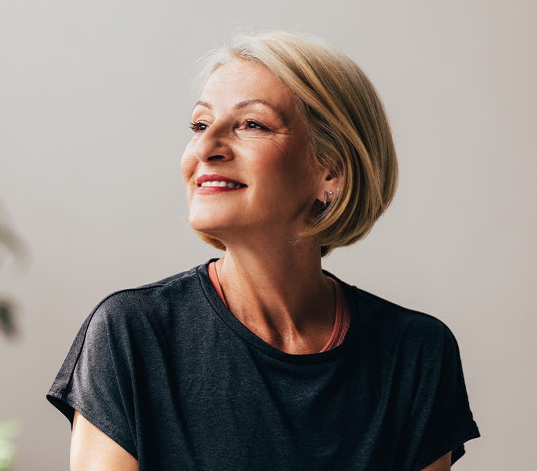 older woman in black shirt smiling
