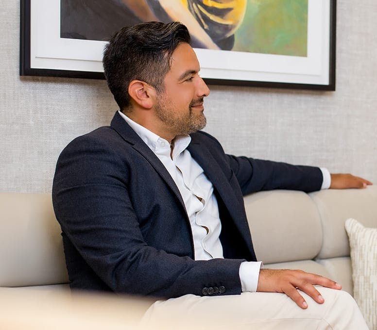 man in suit sitting on couch