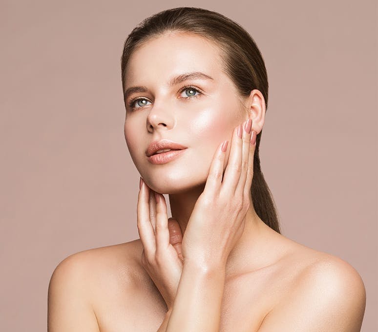 woman looking up with hands around her jaw