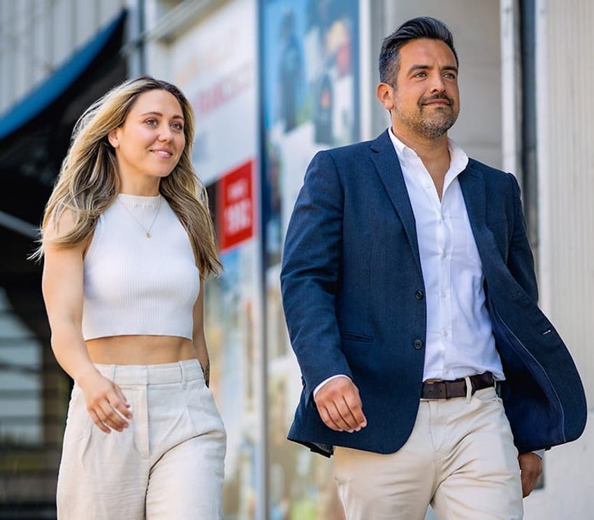 man and woman walking on sidewalk