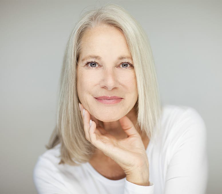 older woman with her hand around her chin