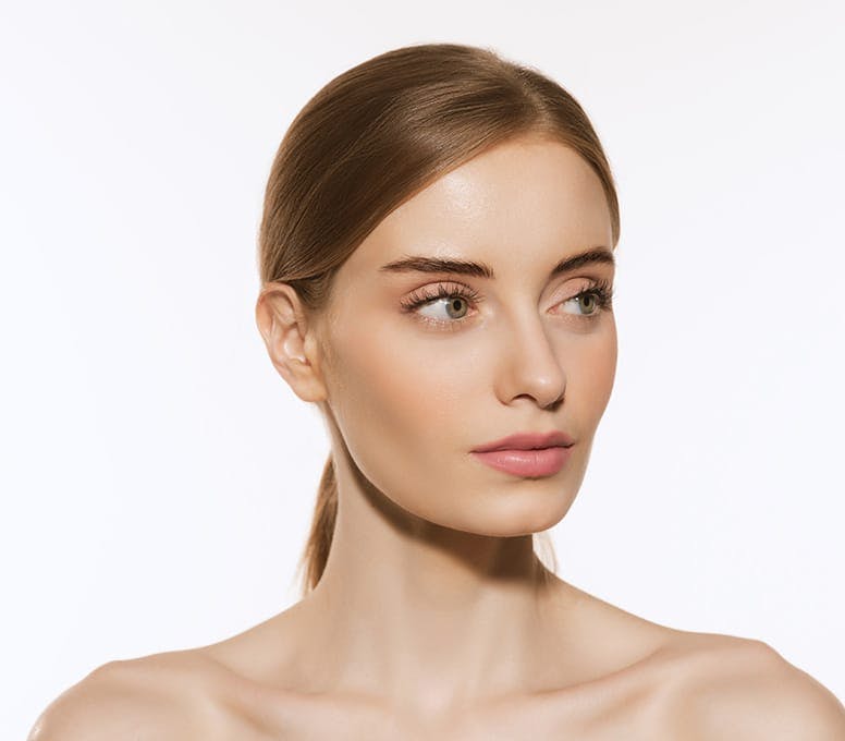 woman with slick ponytail looking to the right